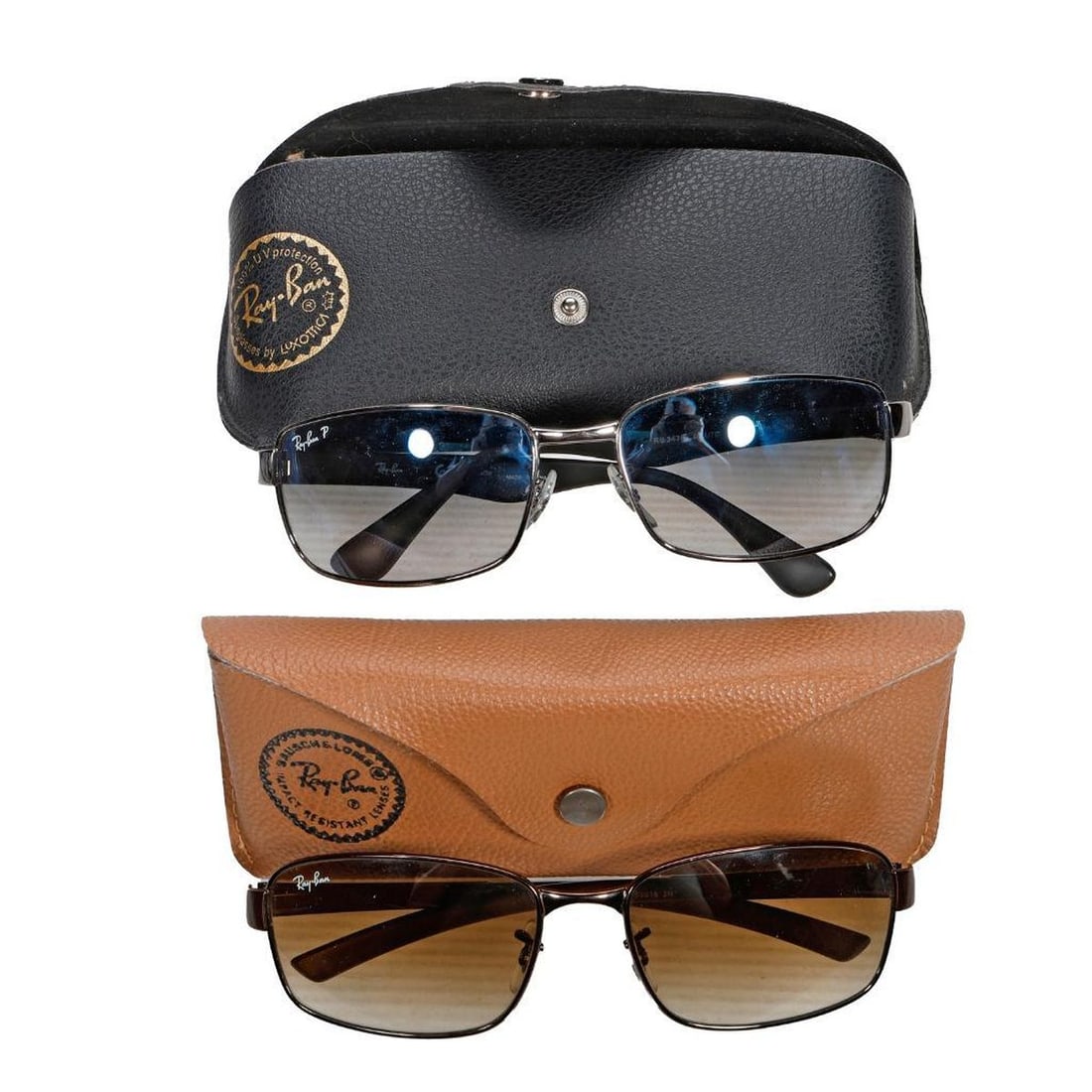 Two Pairs of Ray Ban Sunglasses: Comprising a contemporary pair square glasses gun metal frame with polished blue gray lenses Rb3478; and a pair Italian made Rb3413 glasses; both with "Ray Ban" cases. Provenance: The Estate of Donald