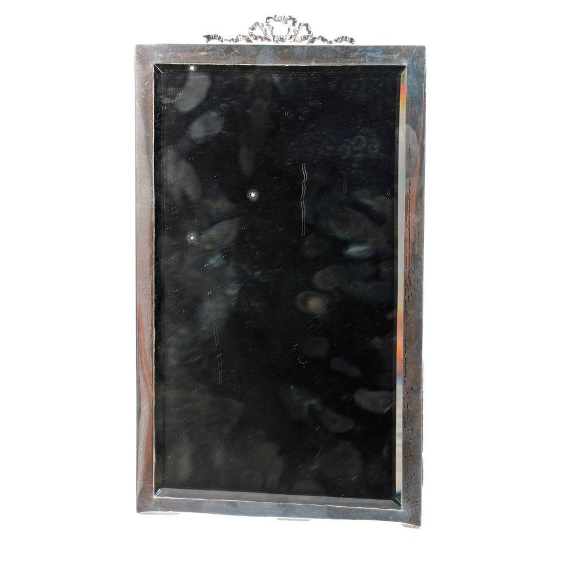 English Sterling Easel Form Mirror: Fashioned in the Louis XVI taste. The English frame bearing hallmarks for Stuart Clifford & Co., Grosvenor Square, London, circa 1910. The rectangular frame centering a silver ribbon tied bow finial h