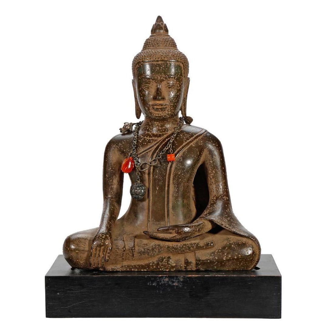 Seated Bronze Buddha: The figure of Buddha cast seated in Bhumpisparsa Mudra, cast with heavy lidded eyes, twin elongated ear lobes, stylized snail shell hair and an ushnisha top, wearing a chatelaine necklace with stone a
