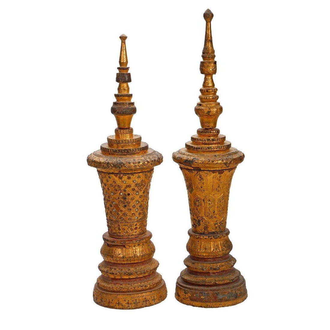 Associated Pair Thai Models of Temple Towers: Each three piece tiered gilt wood replica of a Buddhist temple tower with removable tiered spire and decorative reflective ovals, the taller 17.25"h Condition: losses to the gilt gessoed veneer, heavi