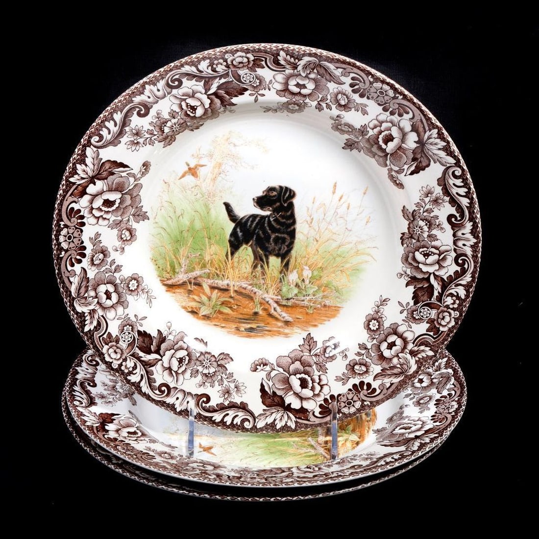Three Spode Hunting Dogs Woodland Plates: Comprising three Woodland plates depicting "HUNTING DOGS/BLACK LABRADOR" two 17/A6 and one 50/A6, 10.75"d, some utensil scratches to the plates, a light scratch to the dogs in each of the plates. Prov