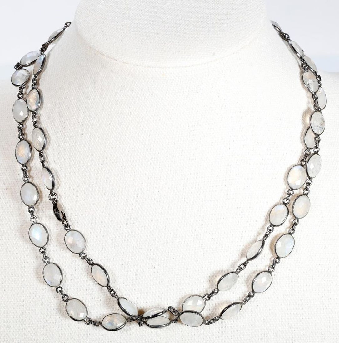 A moonstone and silver longchain: the sterling necklace with oval-shaped rose-cut moonstones; weighing approximately 37.40 grams; length: 35 in.