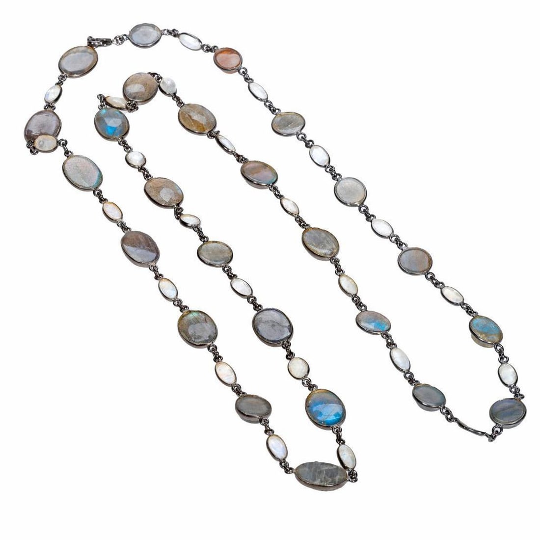A labradorite, moonstone and silver necklace: with stations of oval and round-cut faceted stones, in blackened silver; weighing approximately 39.58 grams; length: 35in.