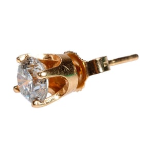 A single diamond and 14k gold solitaire earring