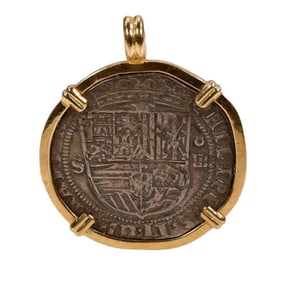 A coin and 18k gold pendant