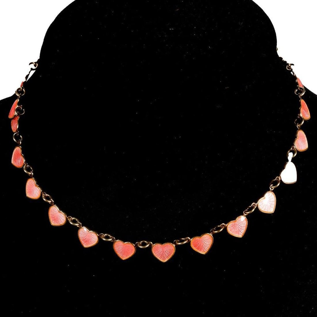 An enamel and sterling silver necklace, Scandinavian: designed with pink enamel heart links; marked M; weighing approximately 17.87 grams; length: 14 1/2 in.