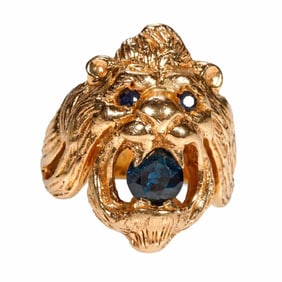 A sapphire and 14k gold lion's head ring