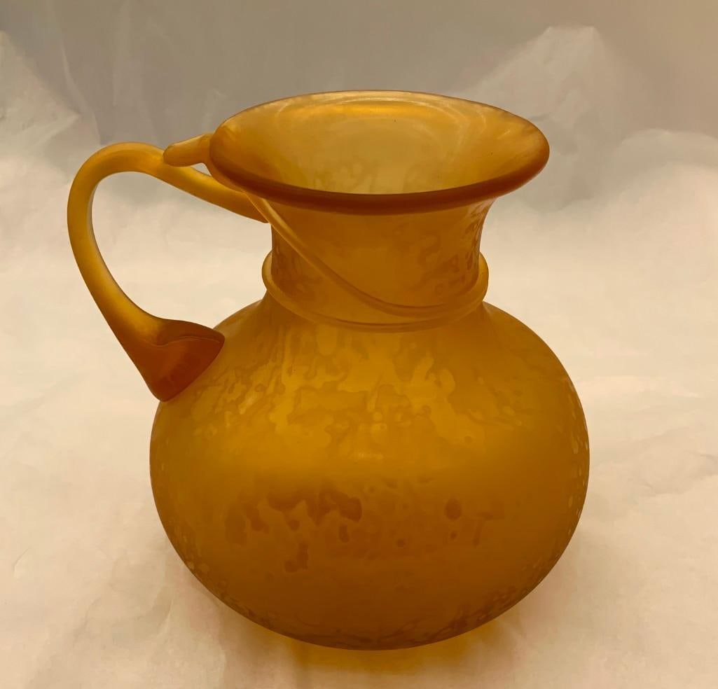 CCAA GLASGALERIE KOLN Glass Vase with handle: Reproduction of antique, pitcher shaped, one handle, frosted amber glass. 6 x 6 inches dia. (15.2 x 15.2 cm dia.) Provenance: CCAA Glass Gallery Cologne These replicas, based on Roman originals from i
