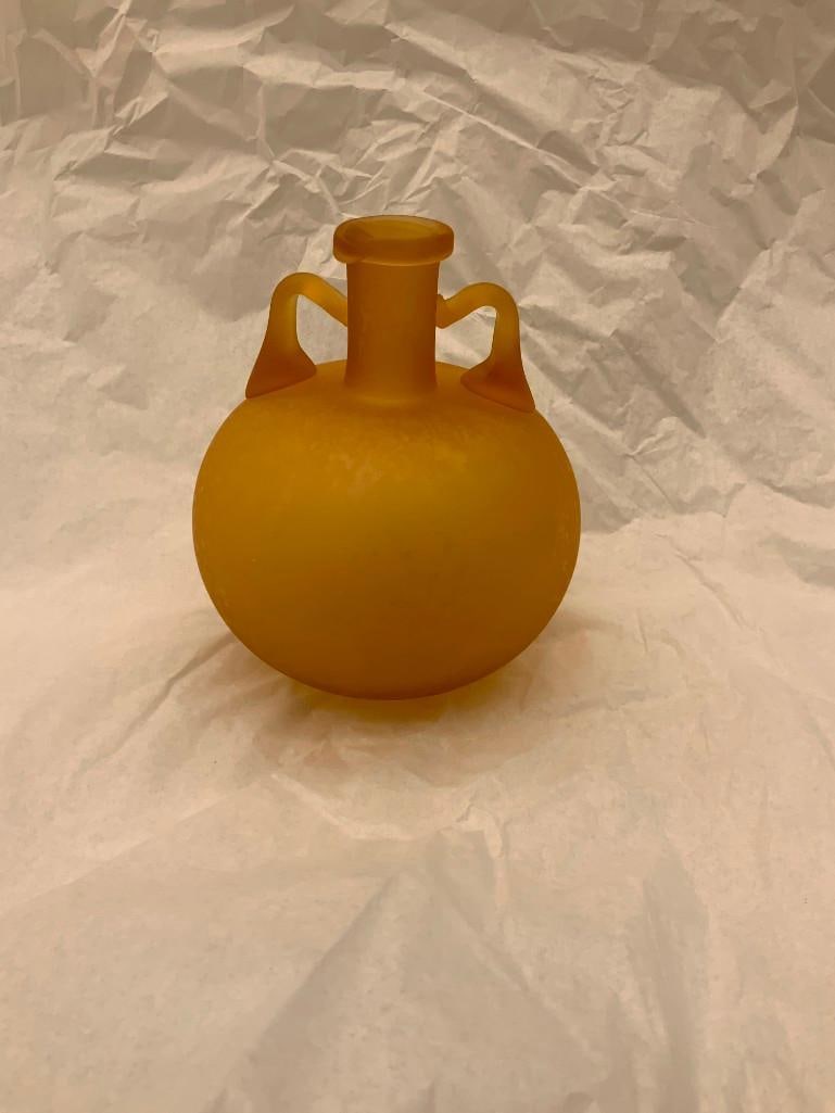 CCAA GLASGALERIE KOLN Glass Vessel (aryballos): Reproduction of antique glass, round shape, two handles, round neck with lip, frosted amber glass. 5 1/2 x 4 1/2 inches dia. (14 x 11.4 cm dia.) Provenance: CCAA Glass Gallery Cologne These replicas, 