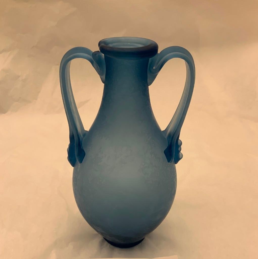 CCAA GLASGALERIE KOLN Glass Amphora: Reproduction of antique glass, amphora shaped, two handles, frosted blue glass. 7 1/2 x 3 1/2 inches dia. (19.1 x 8.9 cm dia.) Provenance: CCAA Glass Gallery Cologne These replicas, based on Roman ori