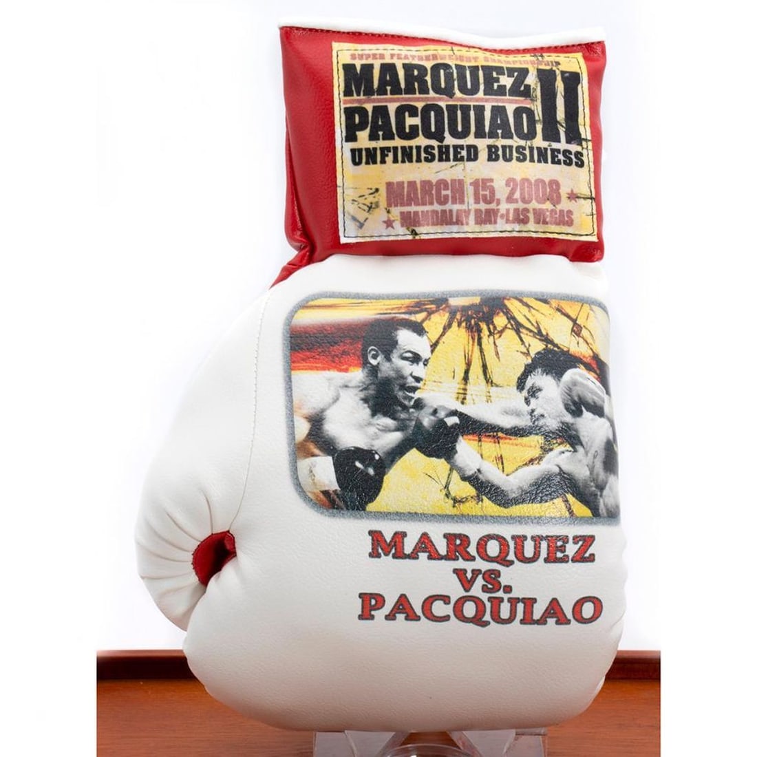 Marquez VS. Pacquiao souvenir boxing glove: Marquez VS. Pacquiao souvenir boxing glove with display case. H: 8.7 inches. W: 15 inches. Depth: 9 3/4 inches.