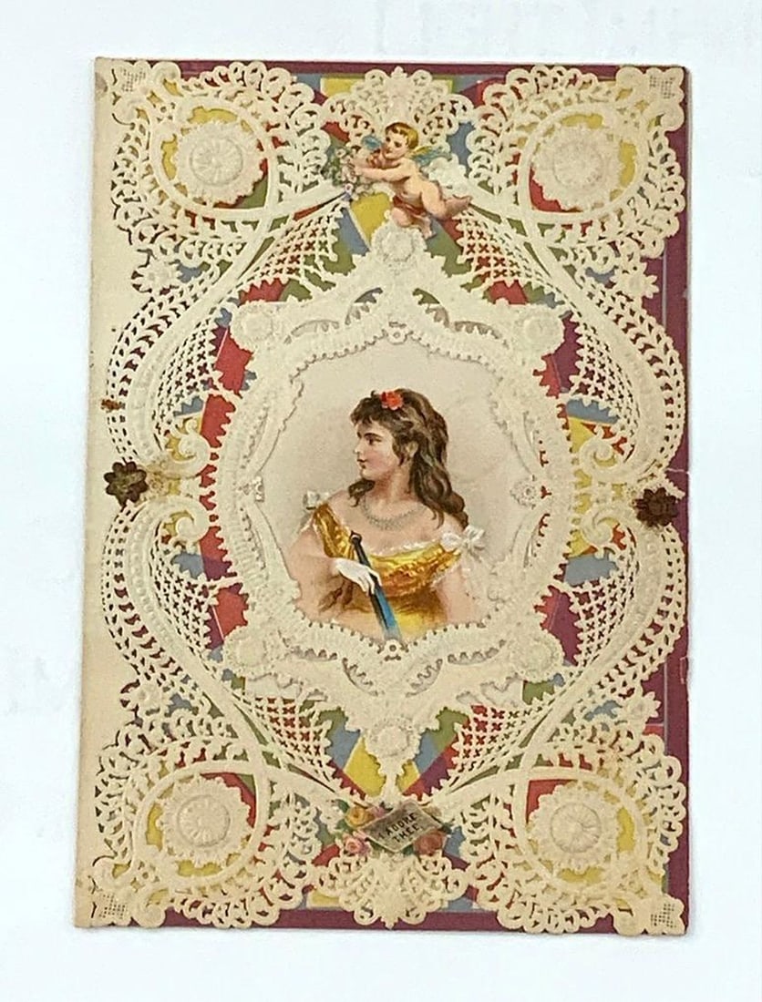 Valentine Card: female figure, "I Adore Thee": Valentine with dark red background, ivory open lace pattern with illustration of a young woman on center, cherub above and small text "I Adore Thee" below, printed greetings behind. Medium: paper, ink