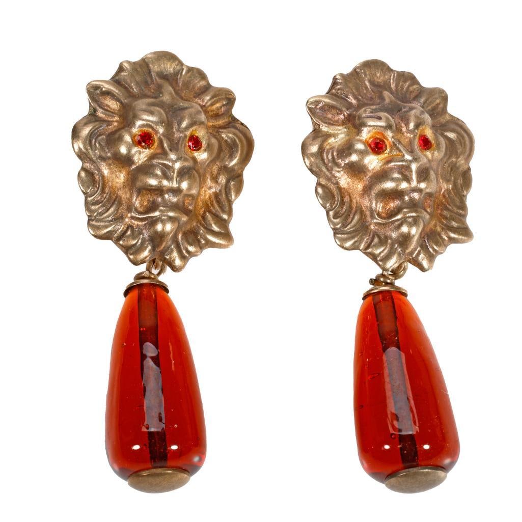 Vintage Bottega Veneta pair of clip earrings: the pair of gilt silver costume earrings of lion's head motif with amber colored glass drops and red eyes; with Italian registry marks; length 2 3/8 in.