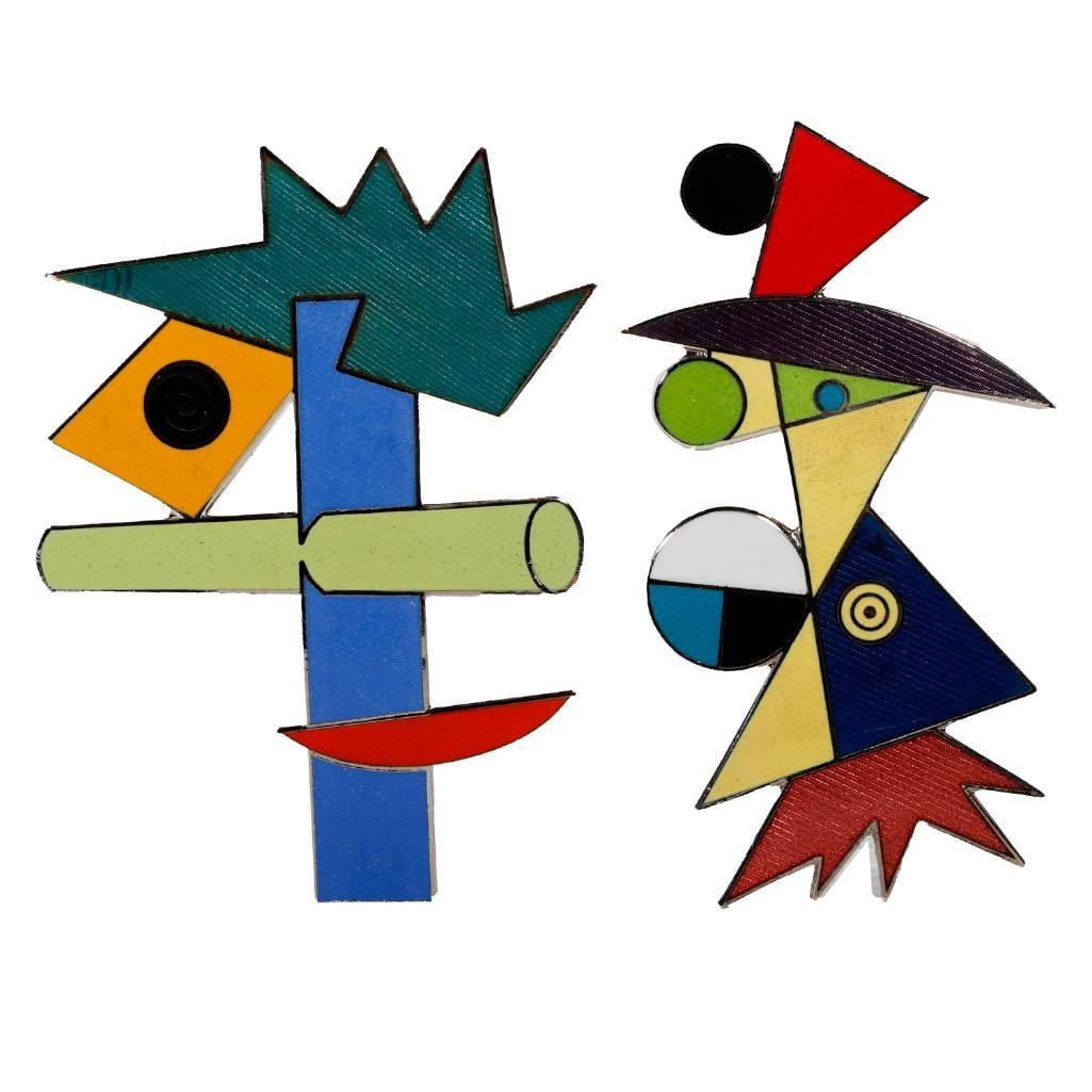 Peter Shire Melrose Emblematic enamel brooches: circa 1985, one Cahuenga, and one Western #77 designs; each stamped Shire for A&M, with signed pouches; lengths: 3in.