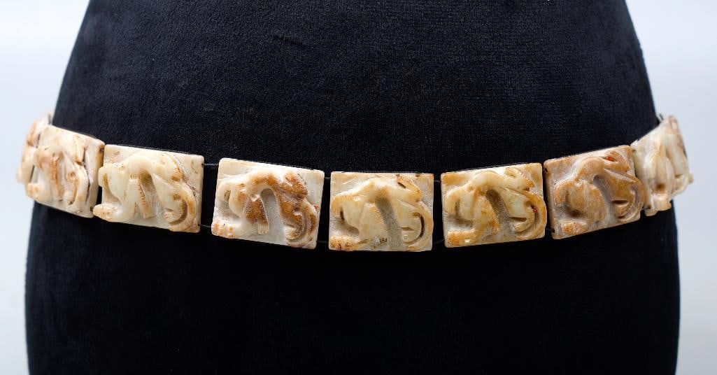 A carved hardstone link belt: composed of rectangular-shaped carved hardstone links, possibly jade, each measuring approximately 1 3/4 x 1 3/8 in; length: 33 in. (one link damaged)