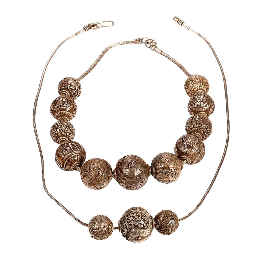 Two silver bead necklaces: of dragon motif, with repouss? beads of assorted diameters: gross weight approximately 229 grams; length: 28 and 24 in.