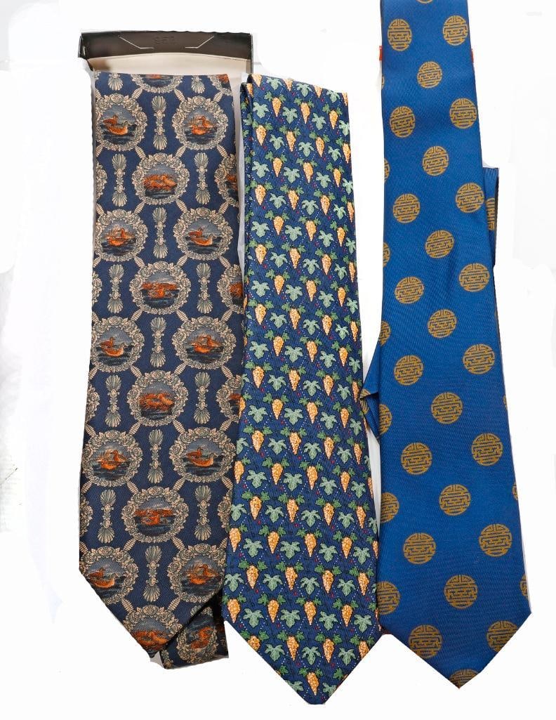 Valentino and Hermes Silk Ties (3): A Hermes, Paris box with two Hermes labeled silk ties: Chinese symbol motif, and grapes/lattice pattern. Together with a Valentino duck pattern silk tie in an I. Magnin box. All in very good condition
