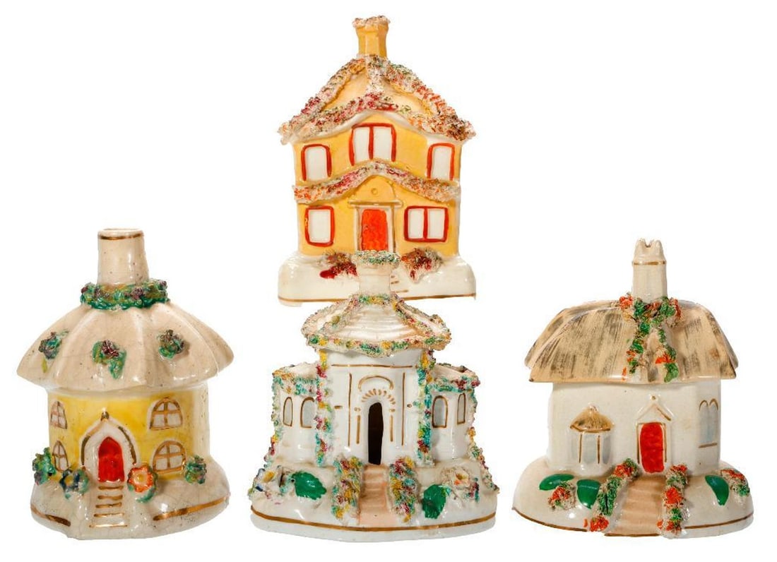 Seven Staffordshire Pastille Burners: Comprising seven Staffordshire pottery small cottage pastille burners, one lidded 4"h; a yellow glazed two-story 4 1/4"h; a hexagonal cottage 4 1/2"h; a pink clock tower castle 6 1/2"h; the largest,