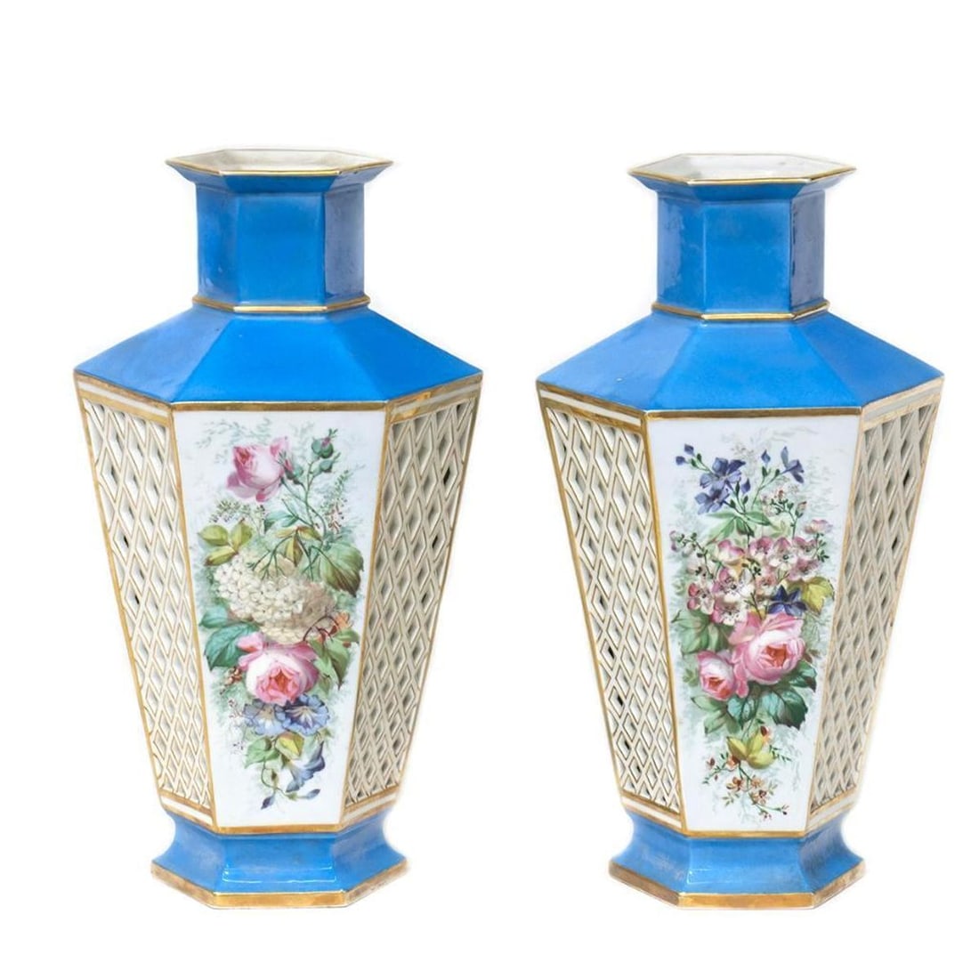 Pair of French Blue Porcelain Vases: Early 20th century, each of hexagonal form reserved against a blue ground with center floral panels. Stamped on base, in oval: "[sun] / 553." 13" x 7". Condition: No chips or visible cracks;