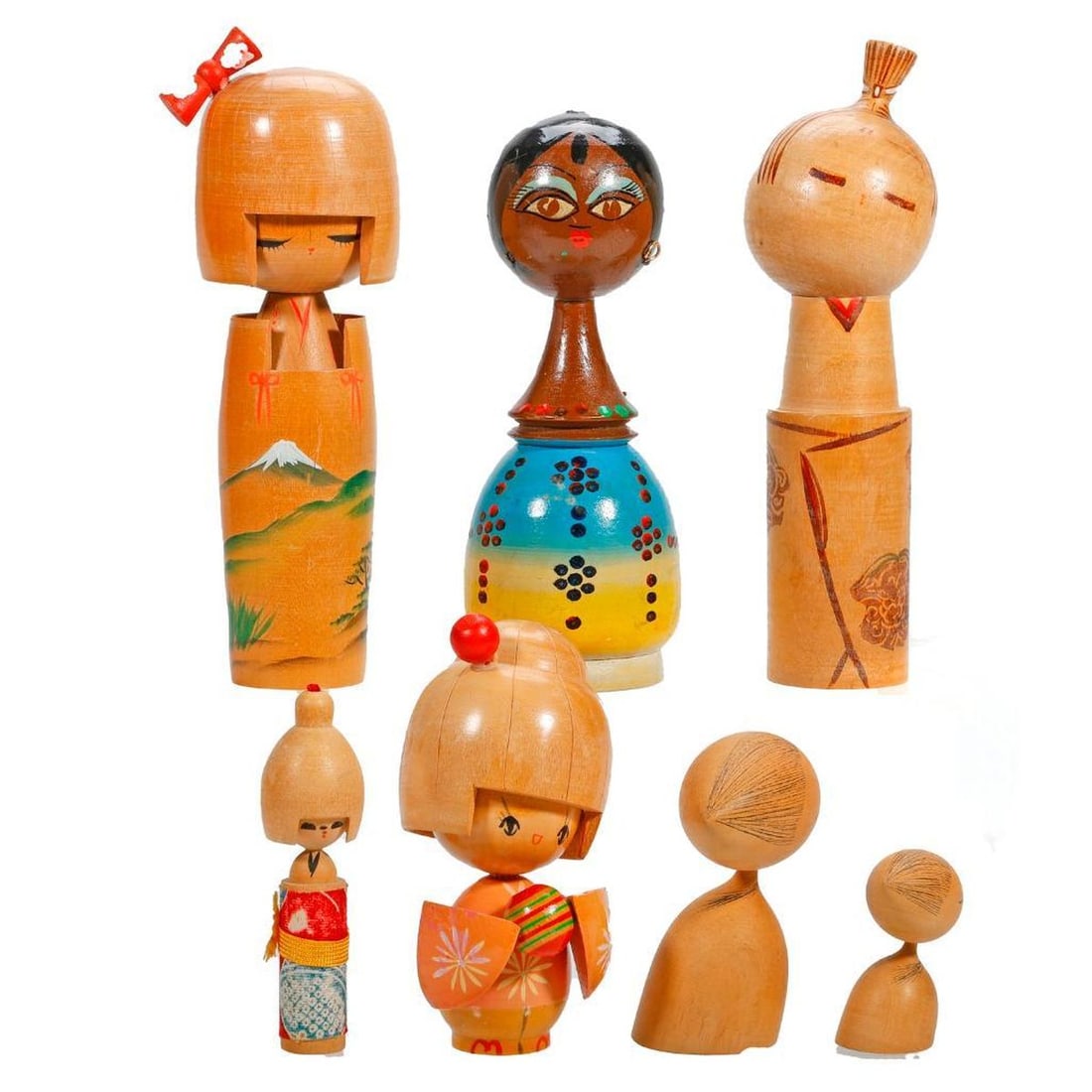 Lot of Mostly Kokeshi Dolls: Including three dolls having an applied "helmet" of bowl cut hair and a seventh tradional Egyptian paint decorated doll, heights range from 2.5" to 7.5". Condition: some light scratches and scuff mark