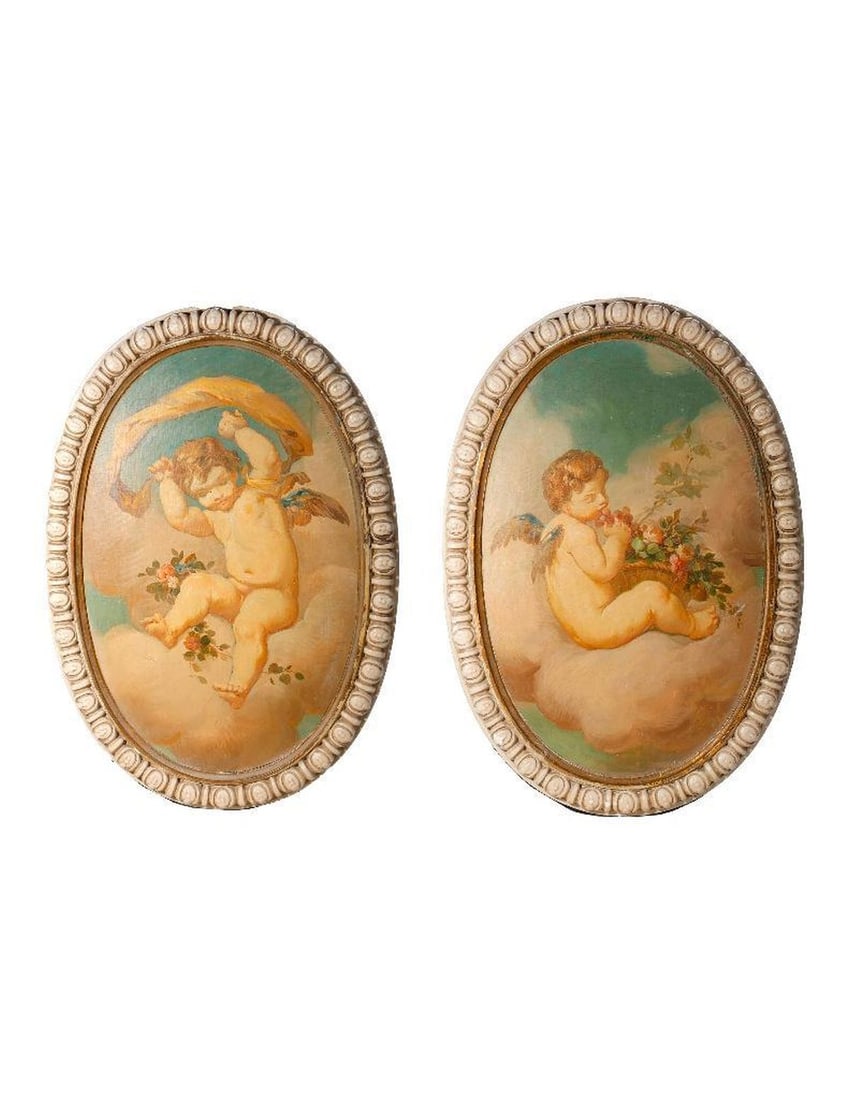 Pair of Rococo Style Architectural Plaques: The oval plaster architectural elements with molded borders, set with putti paintings on canvas laid down. The putti float in clouds, one holding a fruit and floral basket, the other with a ribbo