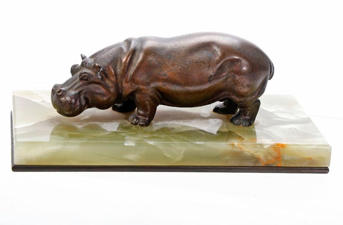 Art Deco Bronze Small Hippopotamus Figure. Property of Alton F. Irby III: A bronze figure of a hippopotamus mounted on a green onyx and metal base (once part of a desk blotter). 1 1/2" H x 4 1/2" L x 1 1/2" W (base 6" x 3"). Provenance: Property of Alton F. Irby III