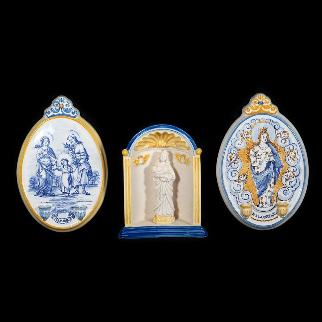 3 Portuguese Ceramic Plaques, incl. Madonna and Child: Two blue and yellow glazed plaques, one with the Holy Family, one with the Virgin (8 3/4in. x 6in.); the other a niche with cherubs and Madonna and Child at (7 1/4in. x 5 3/4in.), chip/old repair on