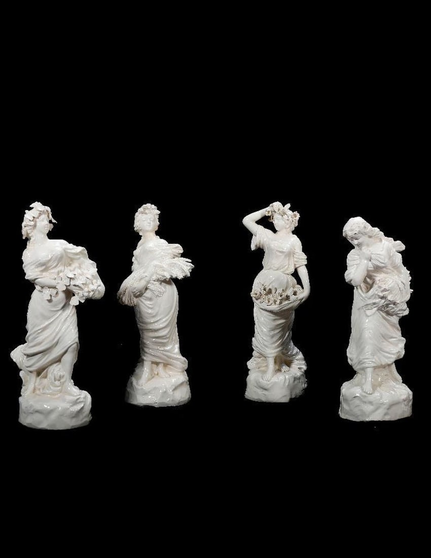 Italian Ceramic Four Season Figurines.: A group of four female figures in Capodimonte style, depicting the four seasons; stamped inside with crowned "N". Ranging from 7" to 7 1/2" tall. Condition: small chips to petals, wheat/branch ti
