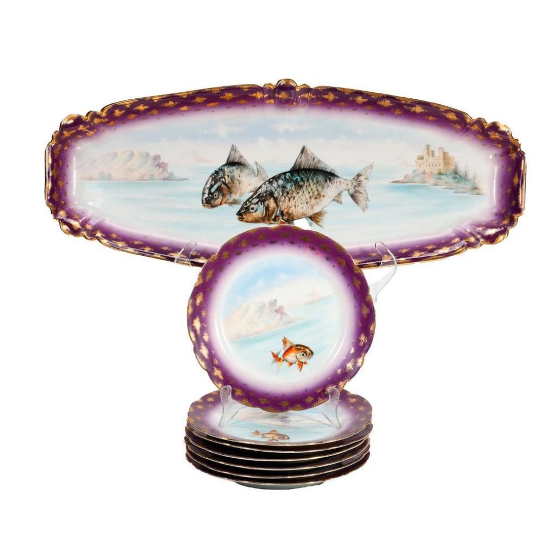 Austrian Porcelain Fish Platter and Plate Set: Marked: A. de R. & Co, Carlsbad, Austria. The hand-painted set with purple and decoration, with central fish and water/landscape motifs. Includes a long oval platter (23" x 9 3/4"), and seven