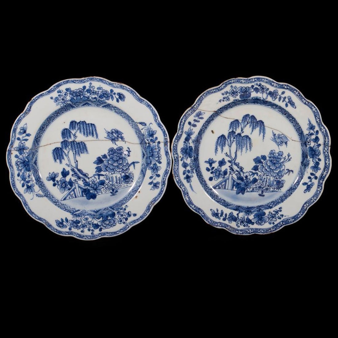 Staffordshire 18th Century Blue & White Porcelain: Each plate cobalt decorated in the manner of Worcester Three Flowers pattern, both staple repaired. 9in. diameter.