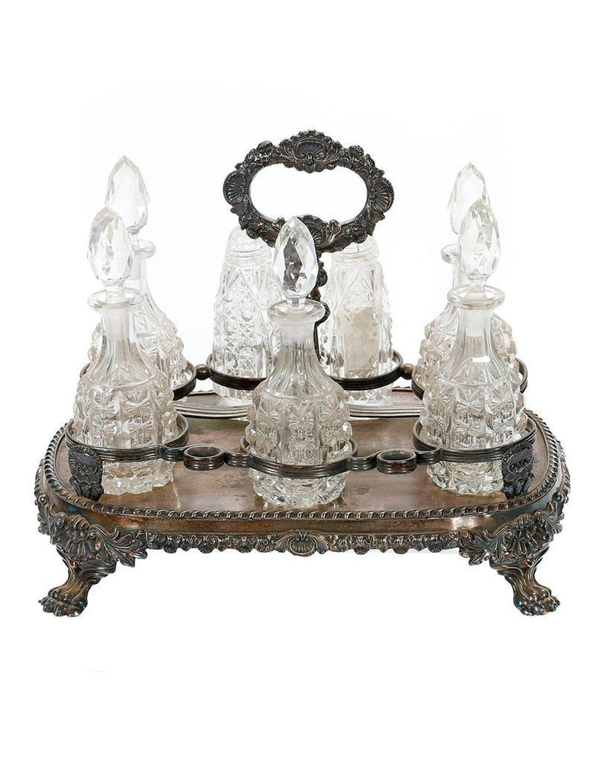 Victorian Cut Crystal and Silver Plate Cruet Set: A 7-piece set including 5 bottles with tops, salt and pepper shakers; overall measuring 10 x 9in.