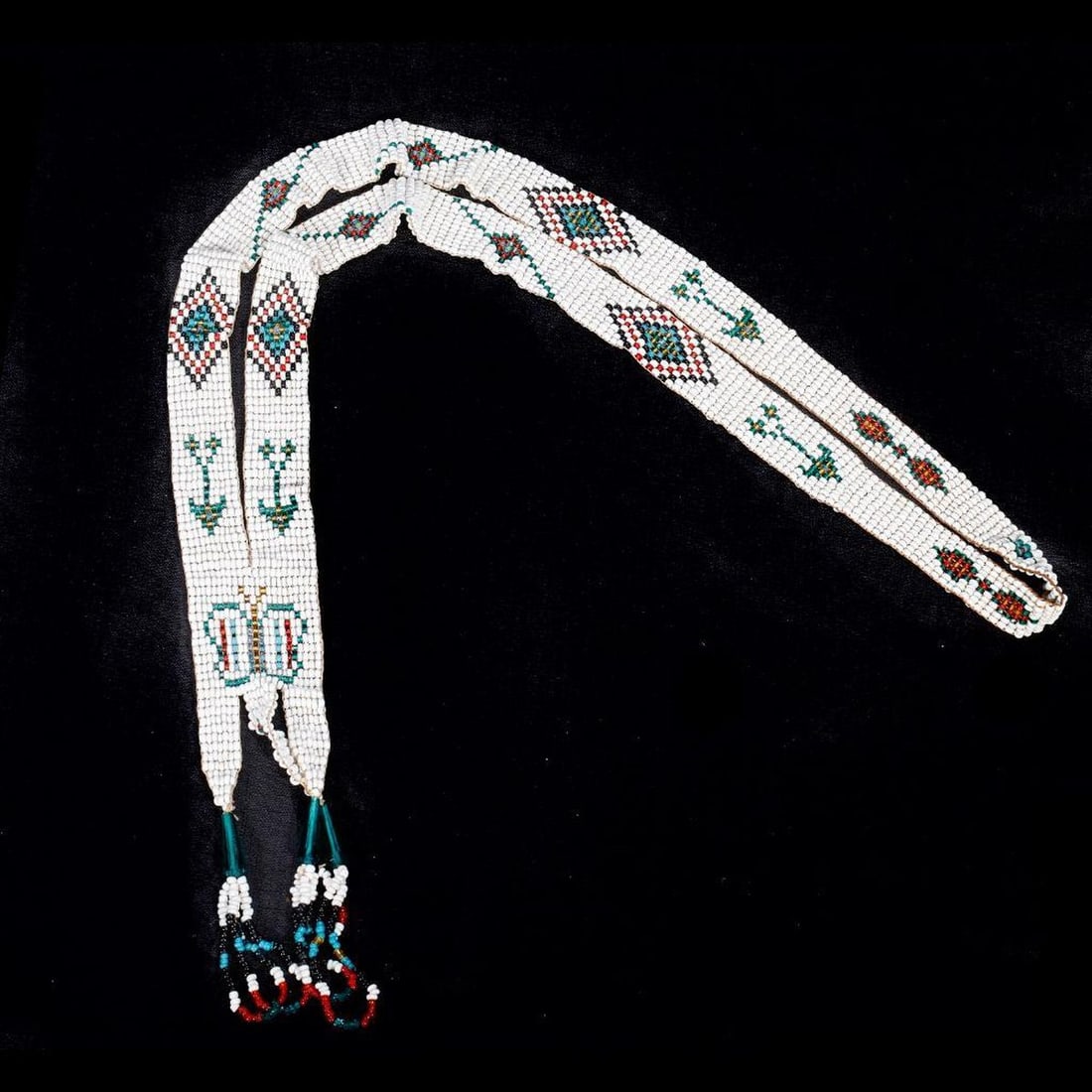 Vintage Native American Beaded Necklace: The Native American/Southwest beaded necklace of butterfly, arrow, and geometric design. Hanging length approx. 21".