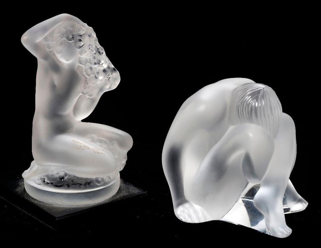 Two Lalique Glass Figurines: Two frosted crystal figures: a crouching nude (2 1/2"), and a seated female nude (3 1/8", mounted on stand). Both etched Lalique, France. Condition: the crouching figure is good; the seated figure