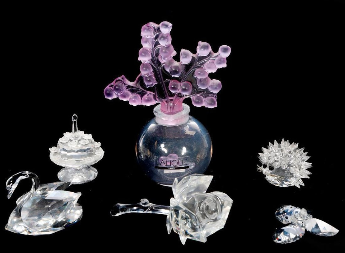 Group Lalique and Swarovski Crystal Collectibles: A Lalique, France marked pale green owl figurine; four crystal miniatures (two marked Swarovski Crystal), including a birthday cake, swan, hedgehog, and a rose (leaves broken/present); a Lalique perfu