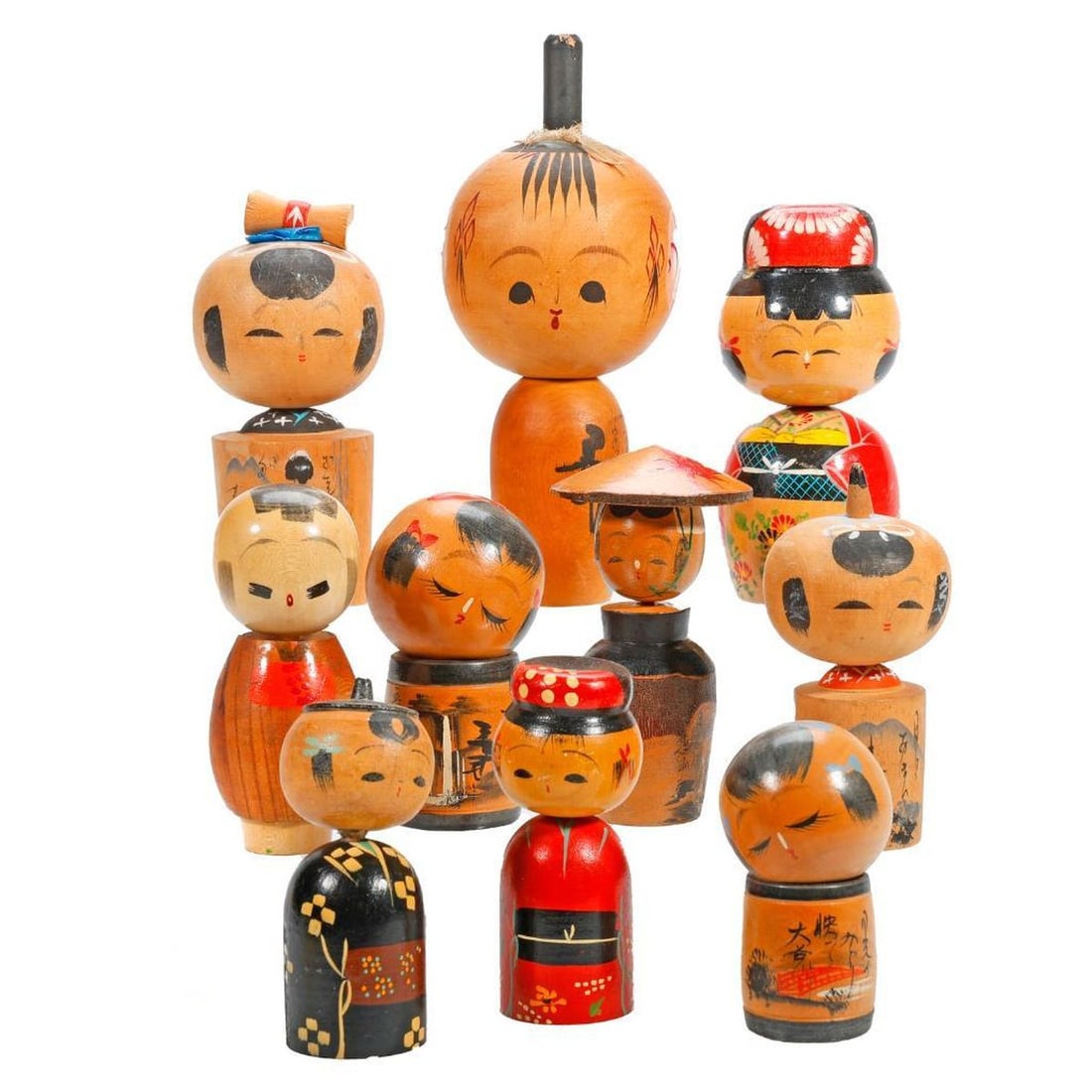 Ten Japanese Kokeshi Dolls: Each with round heads and cylindrical or barrel form bodies, several paint decorated with landscapes and poems, including views of Ito Penisula and two with waterfalls heights range from 3" to 7.