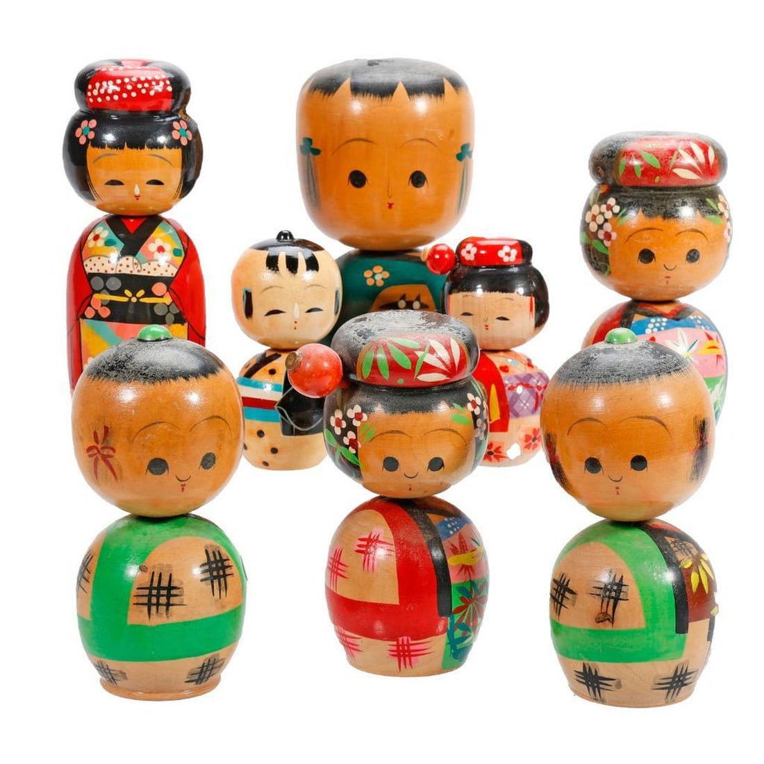 Large Lot of Kokeshi Dolls: Each with round heads and cylindrical or round bodies painted with floral decorative kimonos, together with a doll form toothpick holder, heights range from 3" to 7.25". Condition: nicks, some minor
