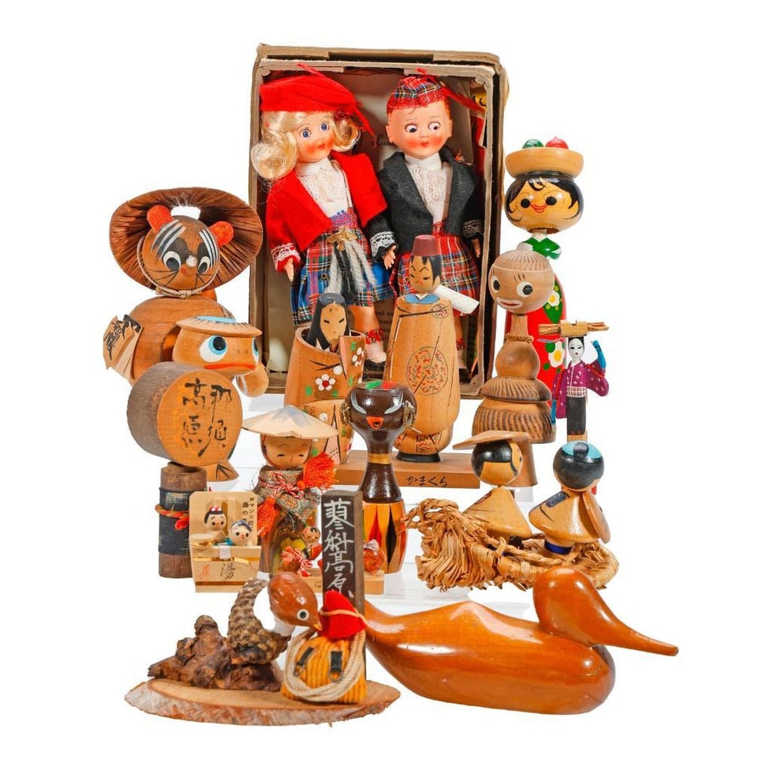 Lot of Souvenir Dolls: Comprising mostly Japanese Kokeshi dolls, including a Carmen Miranda bobble head doll supporting a bowl of fruit 5.5"h; a bobble head frog 3"h; an African Kokeshi doll; and several birds (a minia