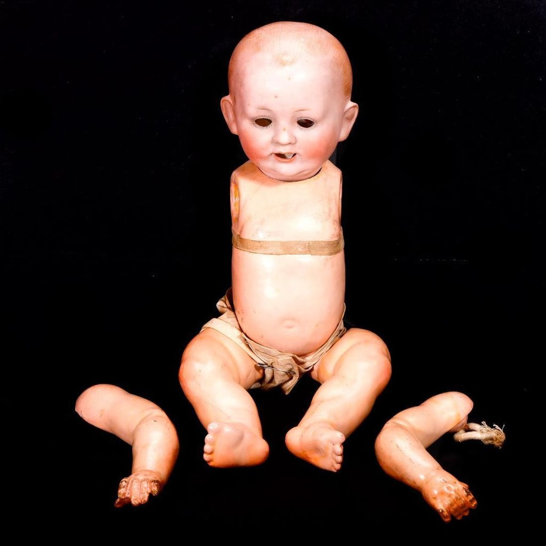 Franz Schmidt Bisque Head Baby Doll: A German bisque head baby doll, marked F. S. & Co. 1272/35Z Deponiert; composite ball-jointed limbs; approx. 14". Condition: arms detached; eyes/elements loose inside the head; cracks/wear to