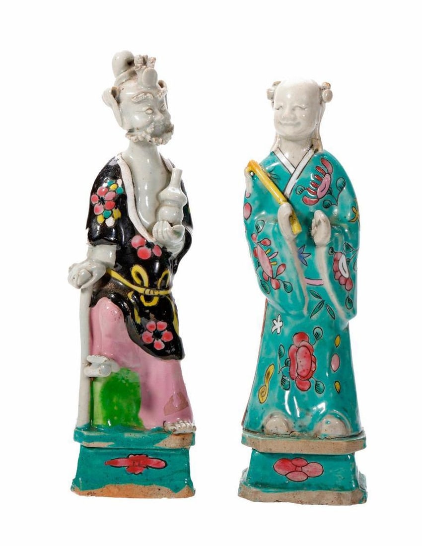 Two Chinese Export Porcelain Immortals. Property of Alton F. Irby III: Late 18th/19th Century. Two porcelain figures of Immortals, depicting Han Xiangzi and Li Tieguai, each over-glaze enamel decorated, standing on plinths. The tallest 9 1/4". Condition: overall good;