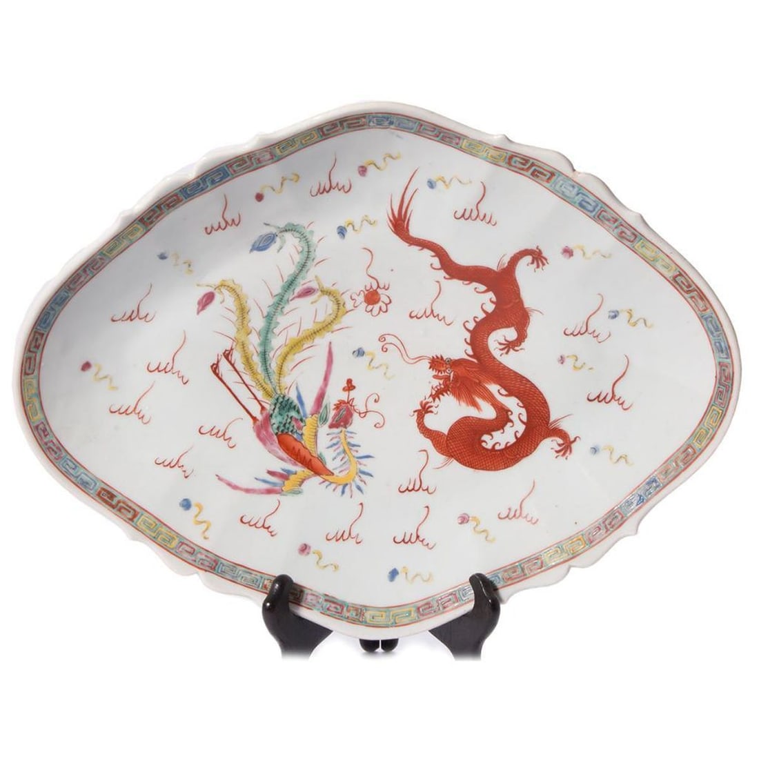 Chinese Dragon/Phoenix Porcelain Footed Platter: Circa Late 19th Century. A Chinese porcelain platter with dragon and phoenix decoration. Red overglaze character mark on base. 3 inches high x 15 x 11. Condition: overall good; one small old repair