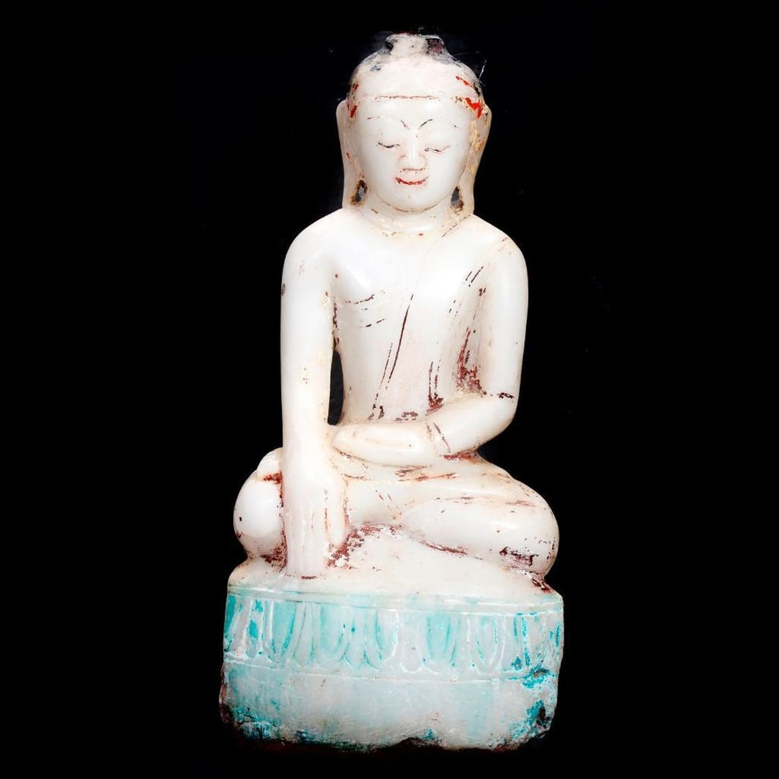 Tibetan Buddha Figure: Carved of alabaster, Buddha seated in Bhumisparsha Mudra, some fragments of polychrome pigments, 17.5"h x 8.5"w x 3.5"d. Condition: losses to the base, wear to pigments