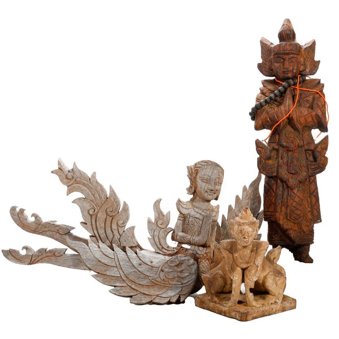 Three Thai Wood Figural Carvings: Comprising a Thephanom guardian figure with associated necklaces of beads and coral colored beads 21"h x 5"w x 2.5"d; a pendant figure of Garuda as a winged goddess 12.5"h x 17.5"w x 5"d; and a