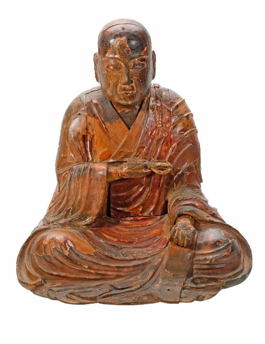 Japanese Polychrome Wood Buddhist Figure: Circa 18th/19th Century. The carved wood monk figure seated and holding a scepter. 9 1/2" x 9 1/2" x 7". Condition: wear and losses to lacquer. With wood platform stand.