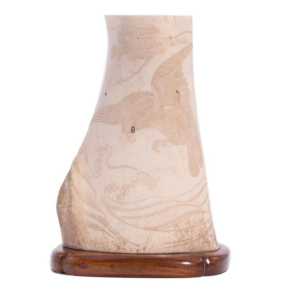 Japanese carving of a falcon on bone.: Late 19th/early 20th century Japanese carving of landscape and falcon on bone mounted on wood stand - 6 inches high x 4 wide x 3 deep.