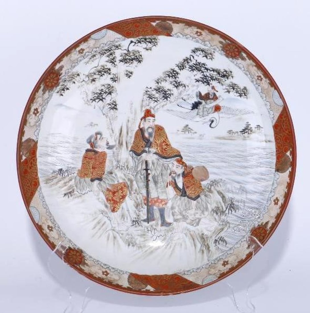 Kutani Ware Porcelain Platter: Porcelain platter with central figures in a landscape; red overglaze mark on base. Height: 2 1/4 inches, Diameter: 14 1/4 inches. Good condition, no chips/cracks.