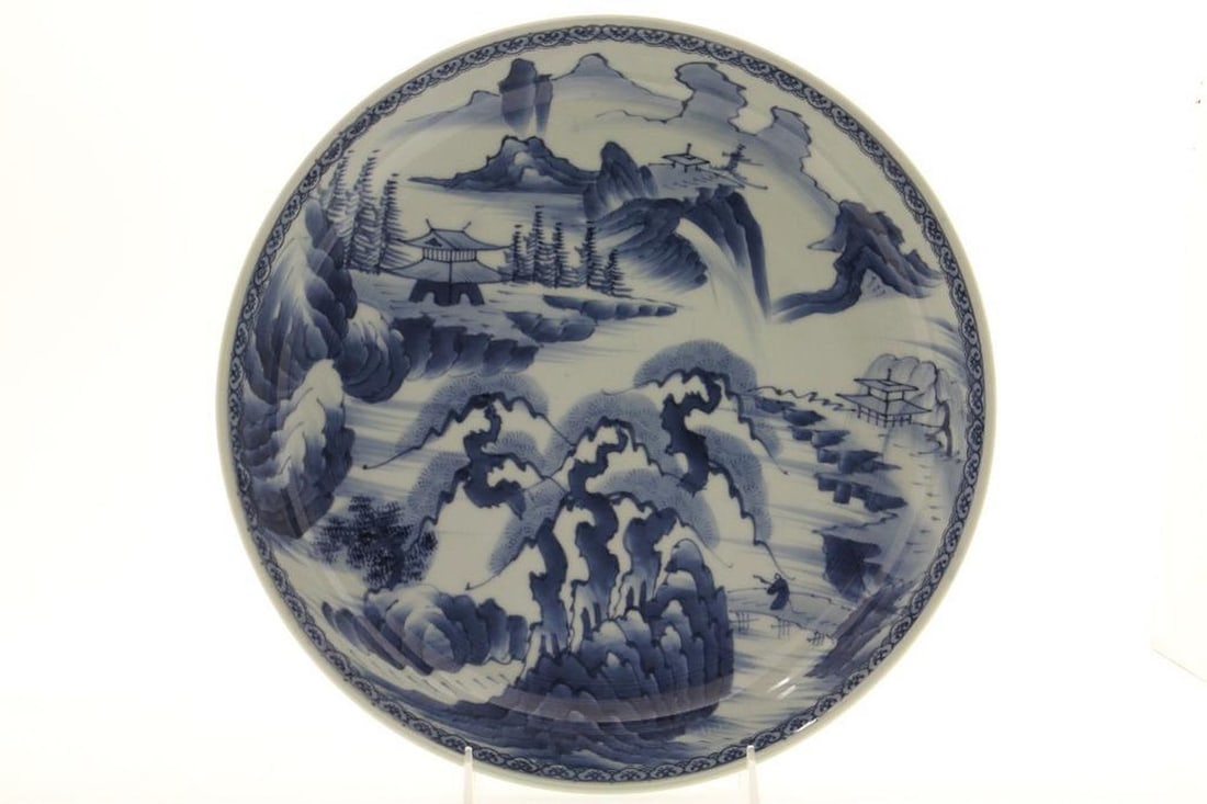 Japanese Arita Blue and White Dish: The large dish with pagoda and landscape motif. Height: 2 3/4 inches Diameter: 13 1/2 inches. Good condition.