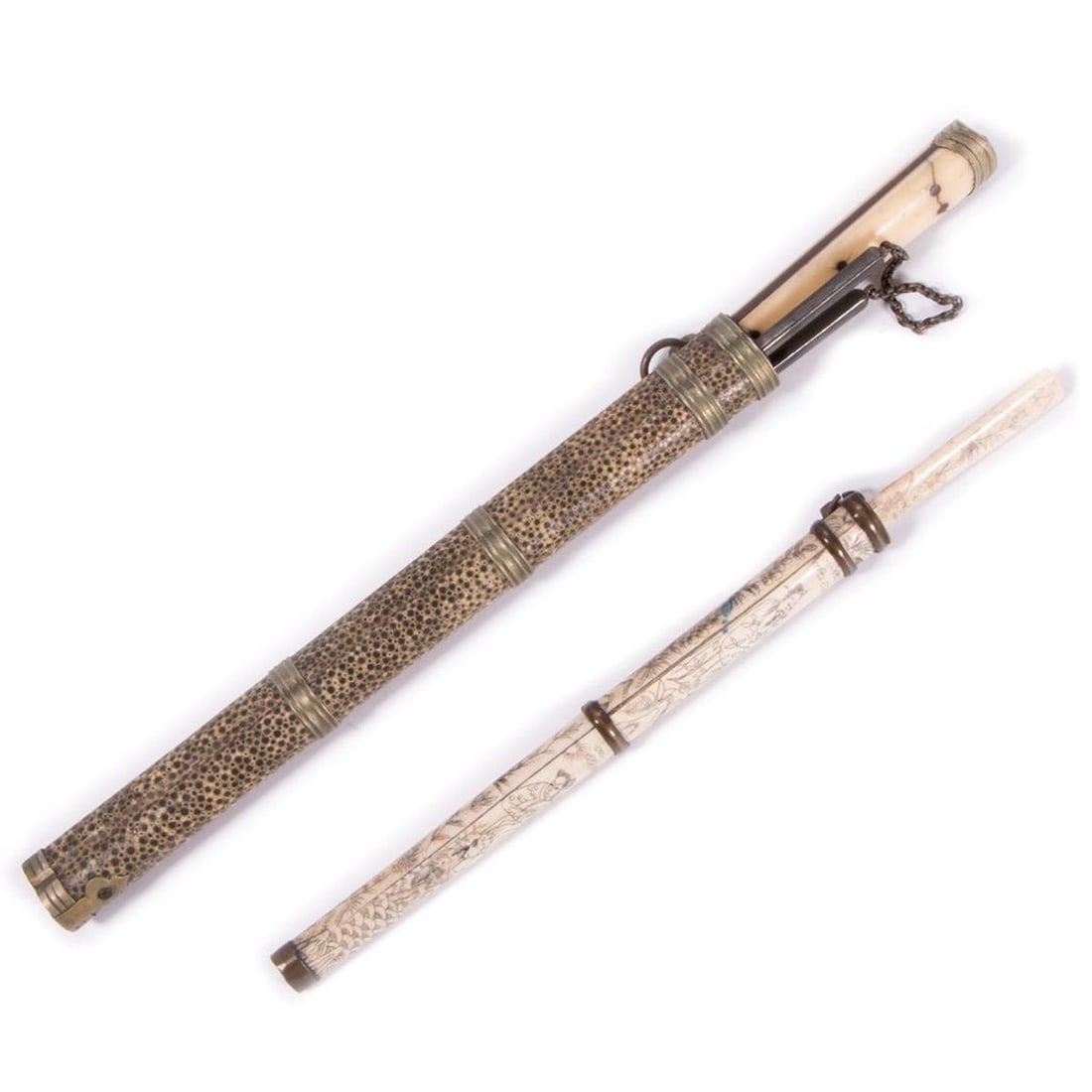 Two Chinese Utensil Sets: Both including a bone handled knife; the first en suite with silver chopsticks (12"l) and a shagreen covered holder (knife with some losses); the second with a case with carved scenes (9.75"l)