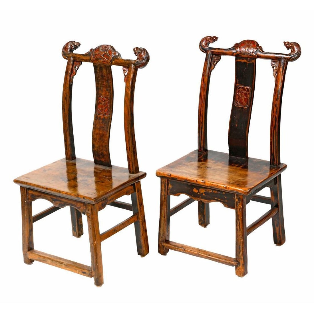 Pair Chinese Child's Dragon Chairs: Late Qing Period. Each yoke back with floral carved camel back crest rail ending in carved dragon heads, over a rectangular block seat, over scalloped carved apron frieze, rising on square legs joined