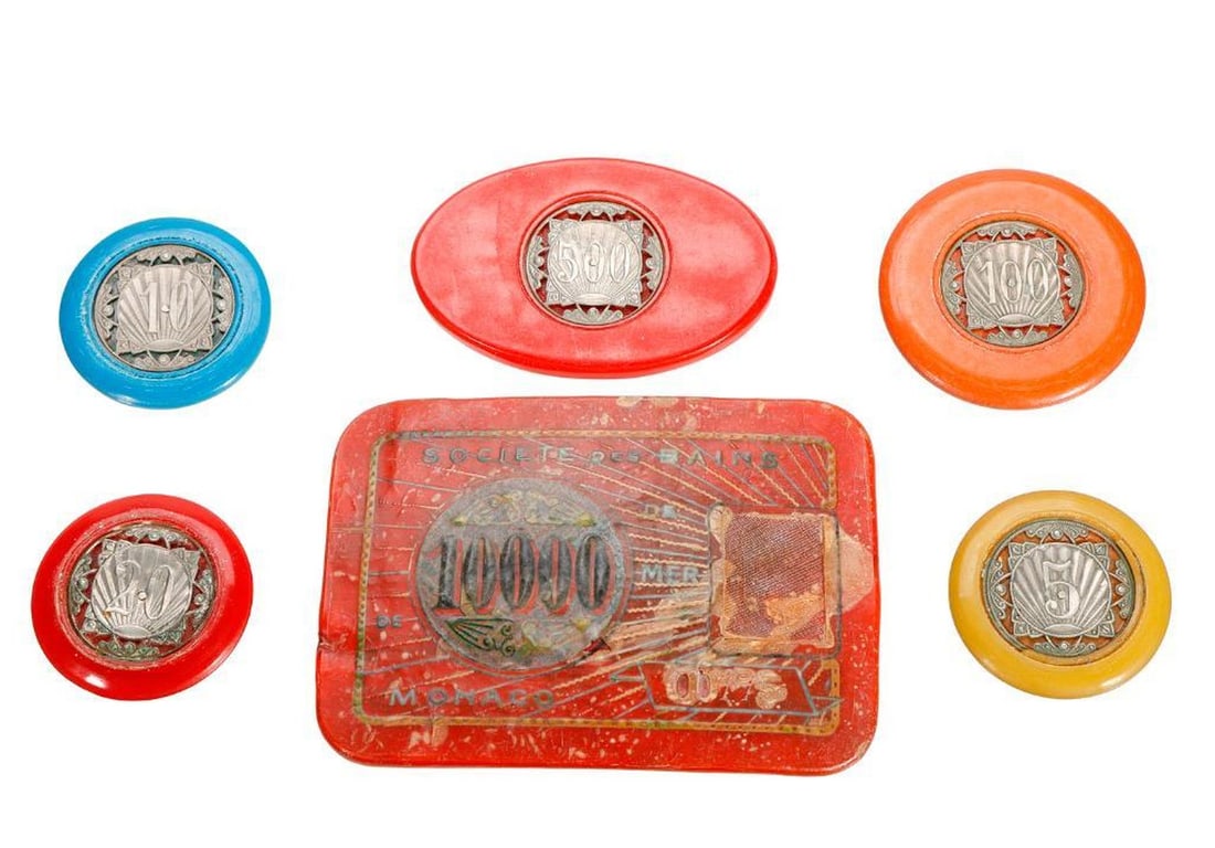 Art Deco Monte Carlo Poker Chips Collection: A collection of 25 circa 1920s/1930s Monte Carlo Bakelite poker chips, in red, orange, blue, and yellow with central pierced metal value medallions; 1 1/2" to 1 3/4" diam. round chips, and five 2 1/2"