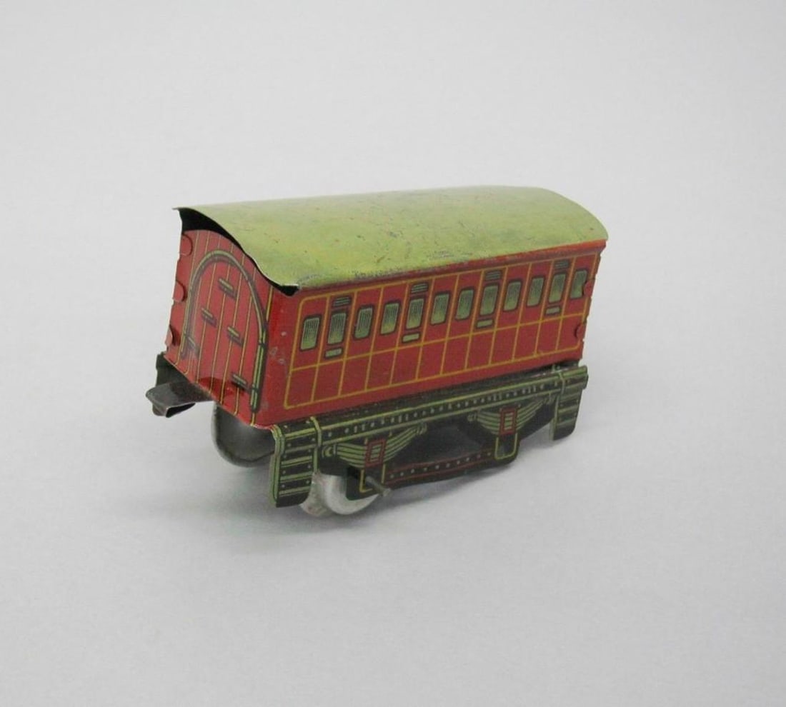 Huki Passenger Train Coach Car: Red toy coach car with green roof. Dimensions: 2 1/4 x 1 1/2 x 3 3/4 inches (5.7 x 3.8 x 9.5 cm). Condition: Bent at side edges. Scattered scratches and paint losses throughout. Slight corrosion on